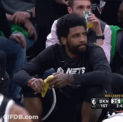 Man In Nets Shirt Sitting In Basketball Stands GIF