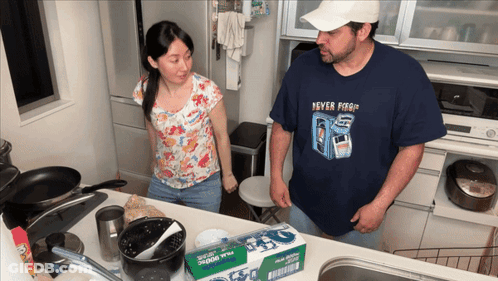 Man In Never Forget Shirt Next To Woman GIF