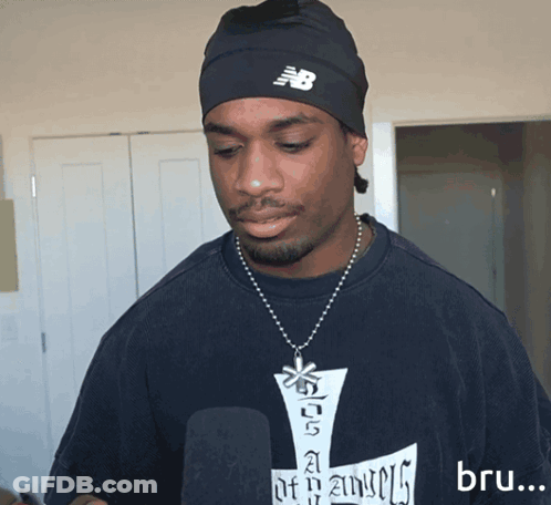 Man In New Balance Beanie And Blue Shirt GIF