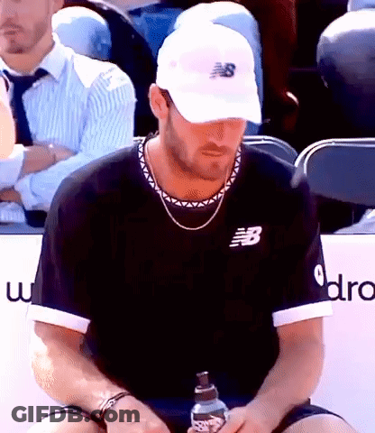 Man In New Balance Hat Holding Water In Stadium GIF