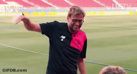 Man In New Balance Shirt On Soccer Field Arms Outstretched GIF