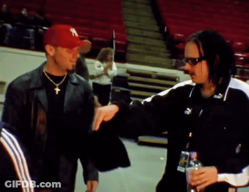 Man In New York Hat Talking To Another Man GIF