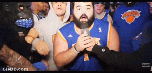 Man In New York Knicks Jersey Holding Microphone GIF