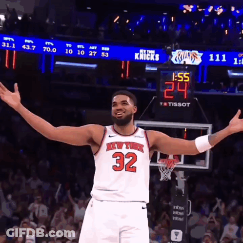 Man In New York Knicks Jersey In Front Of Scoreboard GIF
