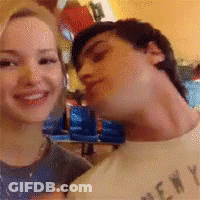 Man In New York Shirt Kissing Woman's Neck GIF
