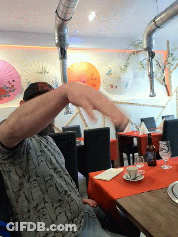 Man In New York Yankees Hat Sitting At Table GIF