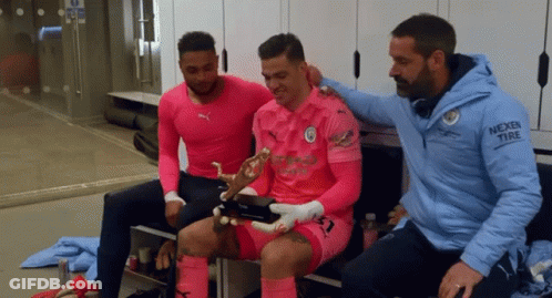 Man In Nexen Tire Jacket Sitting With Two Men GIF
