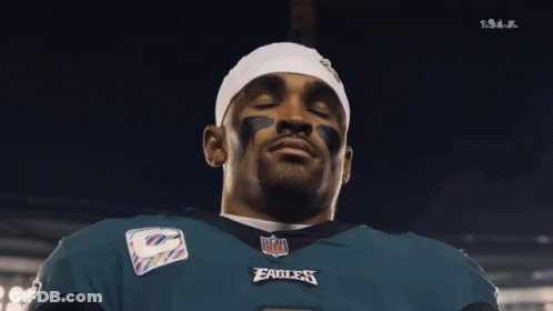 Man In NFL Eagles Jersey Looking Down Eyes Closed GIF