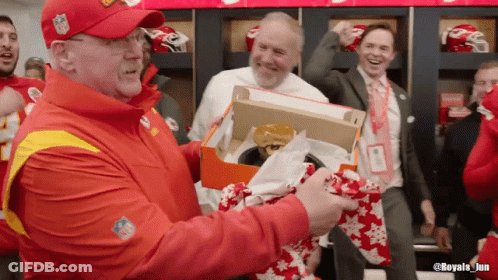 Man In NFL Hat Holding Box With Hamburger GIF