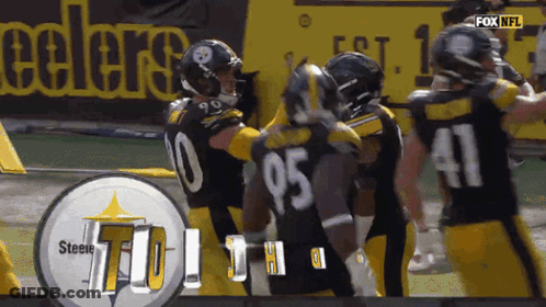 Man In NFL Hat Stands In Crowd GIF