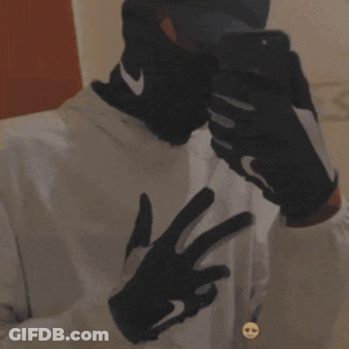 Man In Nike Gloves And Hat Taking Selfie GIF