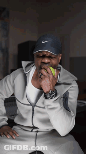 Man In Nike Hat Biting Green Apple GIF