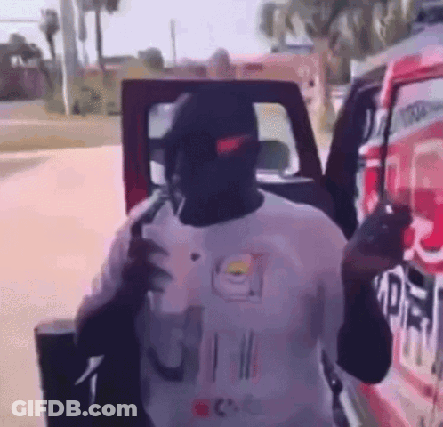 Man In Nike Hat Standing By Red Truck GIF