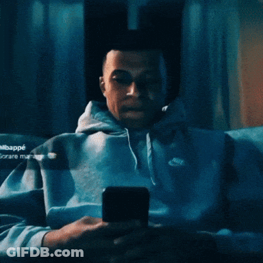 Man In Nike Hoodie Looking Up At Camera GIF
