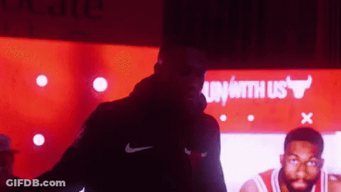 Man In Nike Jacket By Bulls Sign GIF