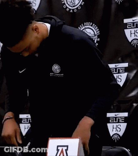 Man In Nike Jacket Standing In Front Of Black Wall GIF