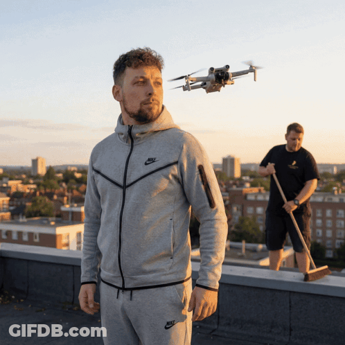 Man In Nike Jacket Watching Drone On Rooftop GIF