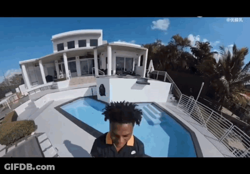 Man In Nike Shirt In Front Of House And Pool GIF