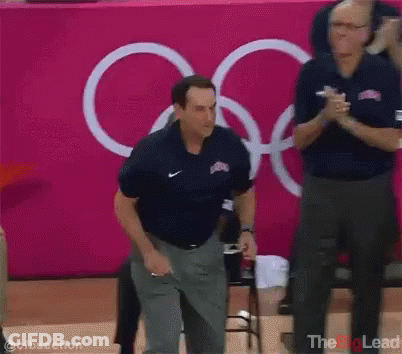 Man In Nike Shirt Pink Wall Olympic Rings GIF