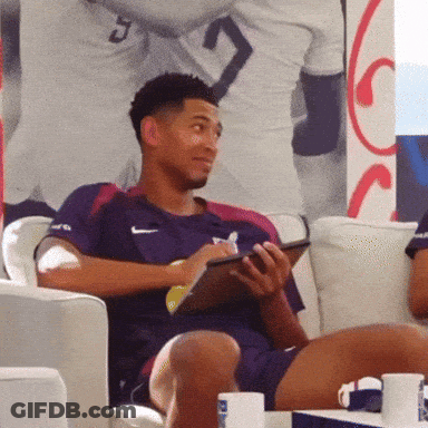 Man In Nike Shirt Sits On Couch GIF
