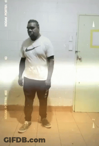 Man In Nike Shirt Standing In Front Of Kodak Portra 400 Film GIF