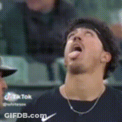 Man In Nike Shirt Sticking Tongue Out In Stadium GIF