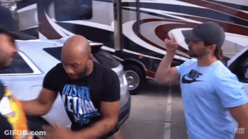 Man In Nike Shirt Talking To Another Man In Parking Lot GIF