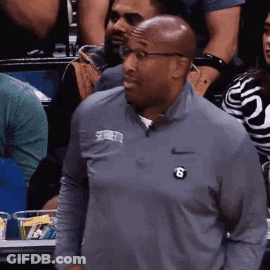 Man In Nike Shirt With Letter S In Crowd GIF