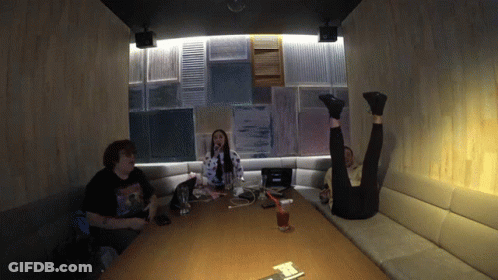 Man In Nirvana T-Shirt Sitting At Table With Two People GIF