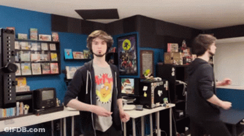 Man In NMS Shirt Standing In Room GIF