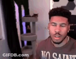 Man In No Saints T-Shirt Sitting At Computer GIF