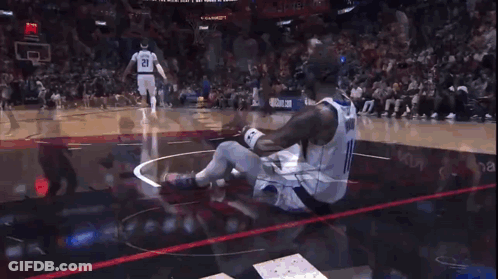 Man In Number 11 Jersey Sitting On Basketball Floor GIF