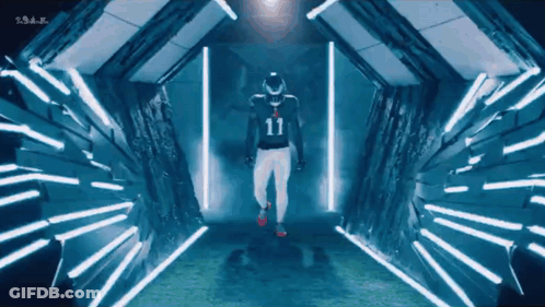 Man In Number 11 Jersey Walking Through Tunnel Of Lights GIF