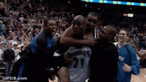 Man In Number 27 Jersey Lifted By Group Of Men GIF