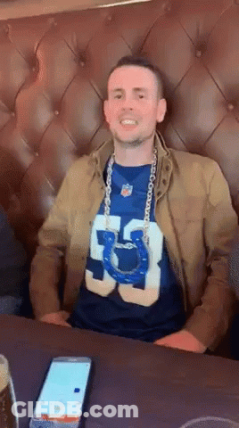 Man In Number 53 Shirt Sitting At Table GIF