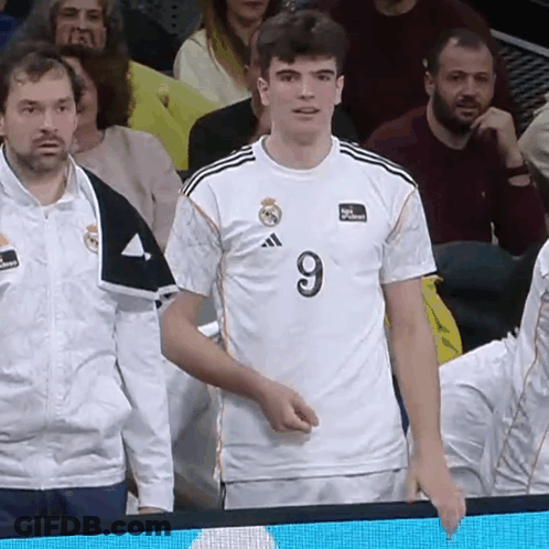 Man In Number 9 Jersey Stands In Crowd GIF