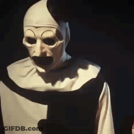 Man In Nun Costume Holding Paper In Dark GIF