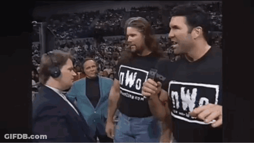 Man In NWO T-Shirt Talking Into Microphone GIF