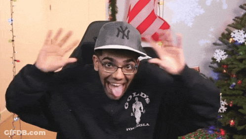 Man In NY Hat And Gold S Gym Sweatshirt Sticking Tongue Out GIF