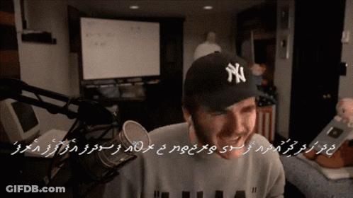 Man In NY Hat At Microphone GIF