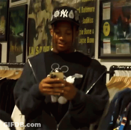 Man In NY Hat Looking At Cell Phone GIF