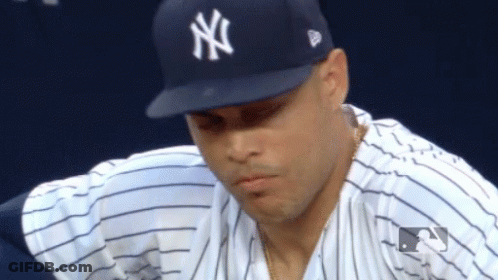 Man In NY Hat Looking Down GIF