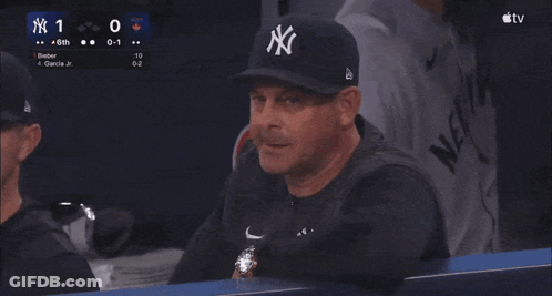 Man In NY Hat Sitting In Dugout At Baseball Game GIF