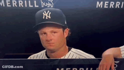 Man In NY Yankees Hat Behind Merri Sign GIF