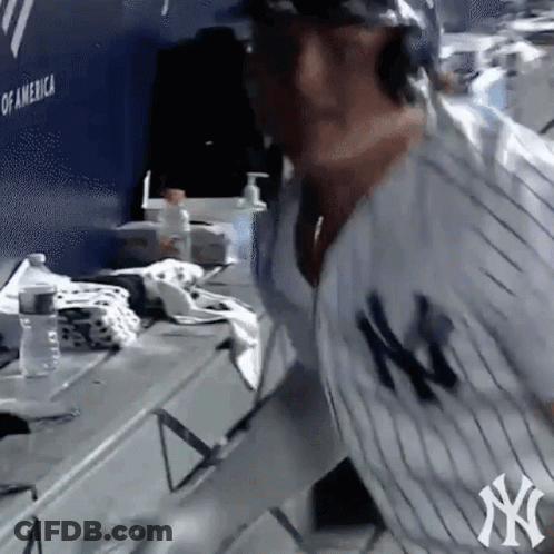 Man In NY Yankees Jersey Standing In Locker Room GIF