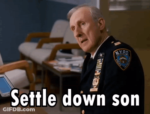 Man In NYPD Uniform Sitting At Table GIF