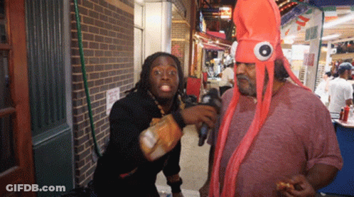 Man In Octopus Costume Talking To Man In Black Shirt GIF