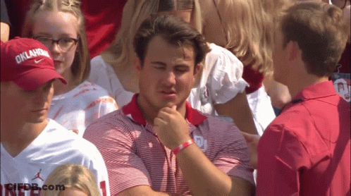 Man In Oklahoma Hat Sits In Crowd GIF