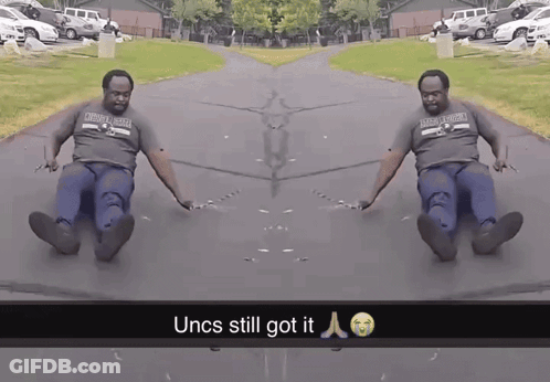 Man In Oklahoma Shirt Sliding Down Road GIF