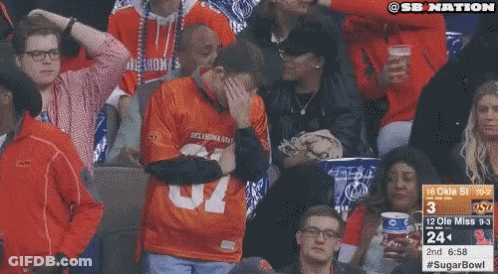 Man In Oklahoma State Jersey Covering Face GIF